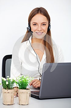 Portrait of happy young support phone operator with headset.