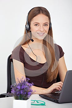 Portrait of happy young support phone operator with headset.