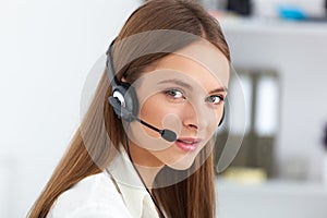 Portrait of happy young support phone operator with headset.