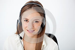 Portrait of happy young support phone operator with headset.