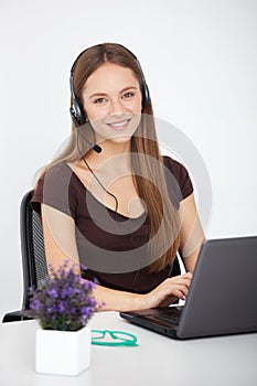 Portrait of happy young support phone operator with headset.