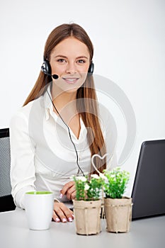 Portrait of happy young support phone operator with headset.