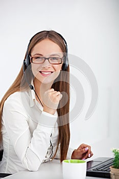 Portrait of happy young support phone operator with headset.