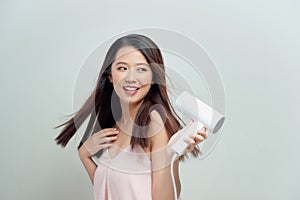 Portrait of happy young woman blow-dry