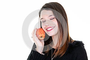 Portrait of happy young woman closed eyes with red apple