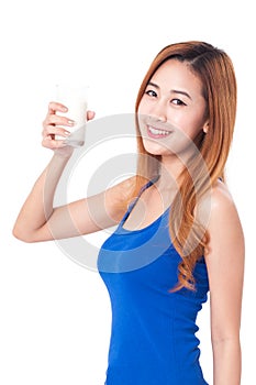 Portrait of happy young woman drinking milk