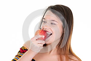 Portrait of happy young woman eating red apple