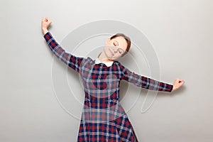 Portrait of happy young woman with eyes closed from pleasure