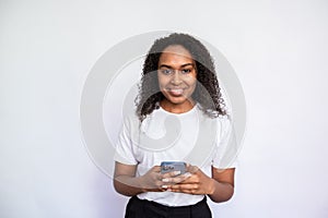 Portrait of happy young woman holding mobile phone