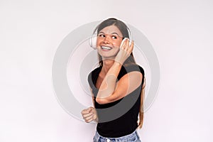 Portrait of happy young woman listening to music in headphones