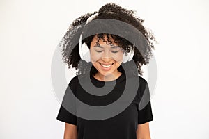 Portrait of happy young woman listening to music in headphones