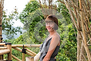 Portrait of happy young woman on the mountains background. Tropical island Bali, Indonesia. Lady in travel.
