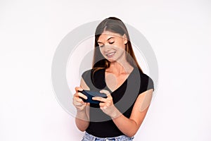 Portrait of happy young woman playing game on mobile phone