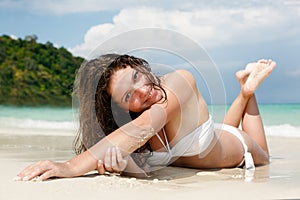 Portrait of a happy young woman posing while on the beach