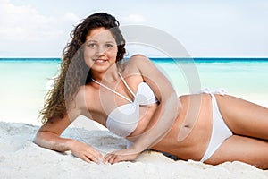 Portrait of a happy young woman posing while on the beach