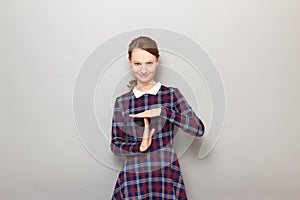 Portrait of happy young woman showing timeout gesture and smiling