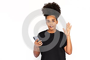 Portrait of happy young woman with smartphone looking at camera