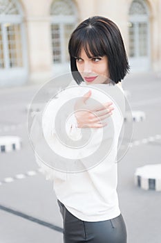 Portrait of happy young woman smiling in paris,