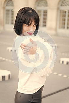 Portrait of happy young woman smiling in paris, france