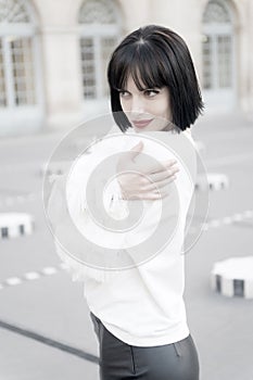 Portrait of happy young woman smiling in paris, france