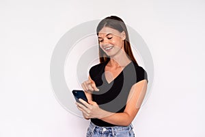 Portrait of happy young woman surfing internet on smartphone