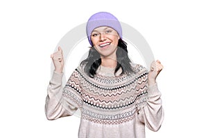 Portrait of happy young woman in sweater hat celebrating winter holidays