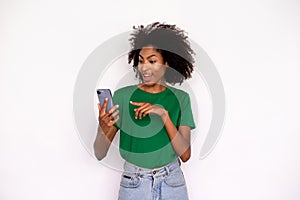 Portrait of happy young woman texting message on mobile phone
