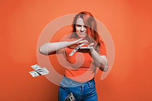 Portrait of a happy young woman, throwing banknotes