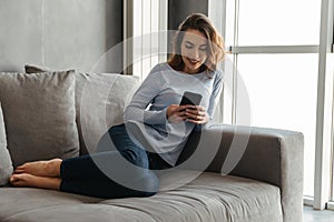 Portrait of a happy young woman using mobile phone