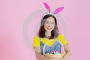 Portrait of a happy young woman wearing Easter bunny ears