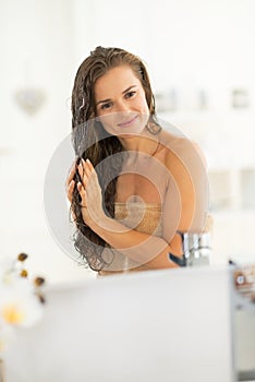 Portrait of happy young woman with wet hairs