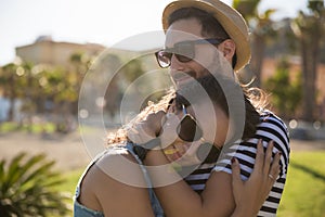 Happy young woman snuggle to her boyfriend outside