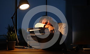 Portrait of hardworking businessman sleeping on big pile important paper folder