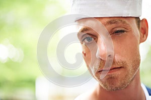 Portrait, hat and man wink outdoor in sailor outfit at music festival, event or summer carnival. Face, blink and serious