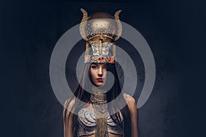 Portrait of haughty Egyptian queen in an ancient pharaoh costume.