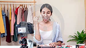 Portrait or headshot of attractive young asian influencer, beauty blogger, content creator or vlogger girl review make up looking