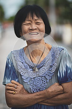 Portrait headshot of old asian woman toothy smiling face