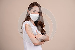 Portrait of health care asian young woman wearing face mask protect, getting vaccine of covid-19, influenza in white t-shirt,