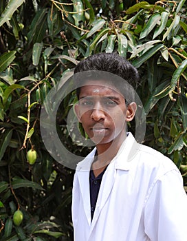 Portrait of a health worker. Picture of a young male doctor wearing a lab coat and standing outside