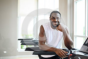 Portrait of healthy black man in fitness sports club. African American smiling and looking at the camera