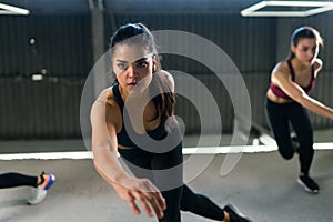 Portrait of a healthy fit woman taking a HIIT class