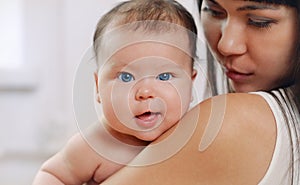 Portrait of healthy newborn baby with big blue eyes, motherhood