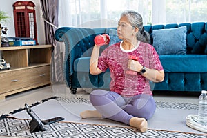 Portrait healthy senior woman doing exercise with  lifting dumbbells