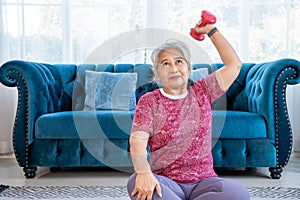 Portrait healthy senior woman doing exercise with  lifting dumbbells