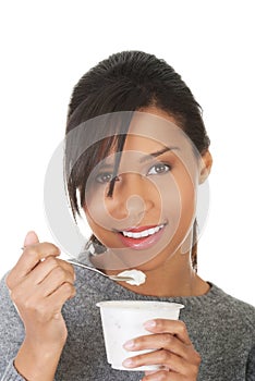 Portrait of healthy woman eating yoghurt