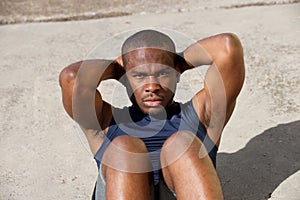 Healthy young black man doing situps outside photo