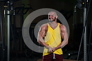 Portrait of a healthy young Caucasian man posing in the gym and flexing his muscles