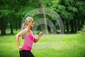 Portrait of a healthy young woman jogging in the park