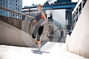 Portrait of a healthy young woman running outdoors.