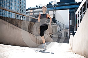 Portrait of a healthy young woman running outdoors.